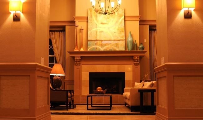 a room with a fireplace and a painting on the wall