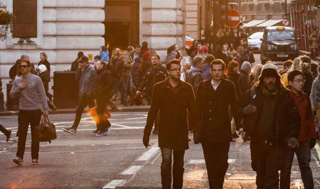 a group of people walking on a street
